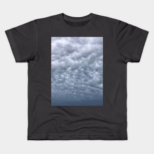 Under cloudy heavenly sky. Blue grey cumulus cloudscape Kids T-Shirt